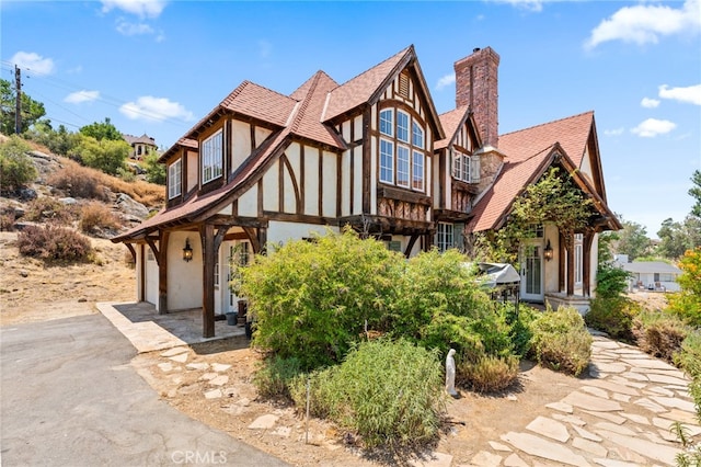 tudor house featuring a garage