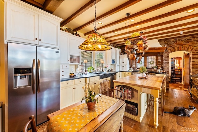 kitchen with white cabinetry, butcher block counters, appliances with stainless steel finishes, and dark wood-type flooring