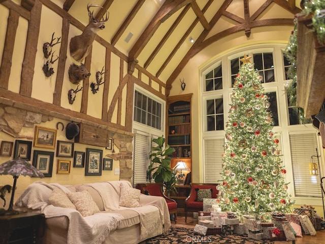 living room featuring high vaulted ceiling and beamed ceiling