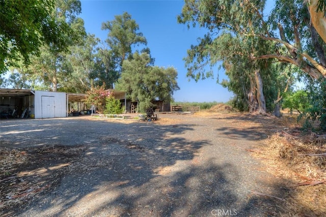 4065 County Rd S, Orland, CA 95963 - view of yard featuring an outdoor structure and a carport