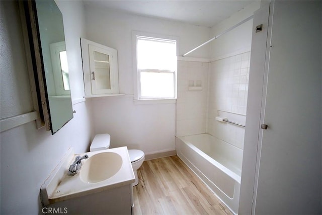 full bathroom featuring vanity, hardwood / wood-style flooring,  shower combination, and toilet