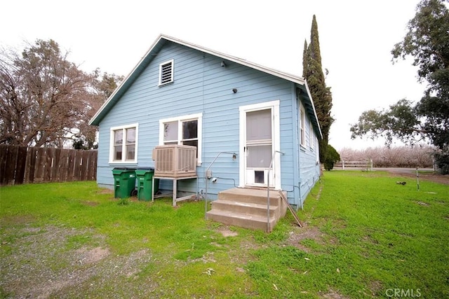 rear view of house featuring a yard