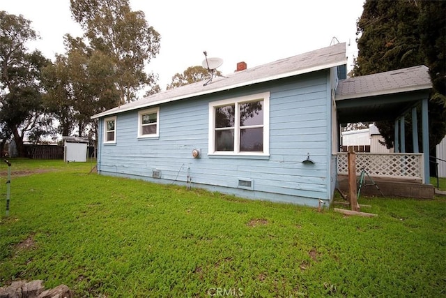 back of property with a lawn