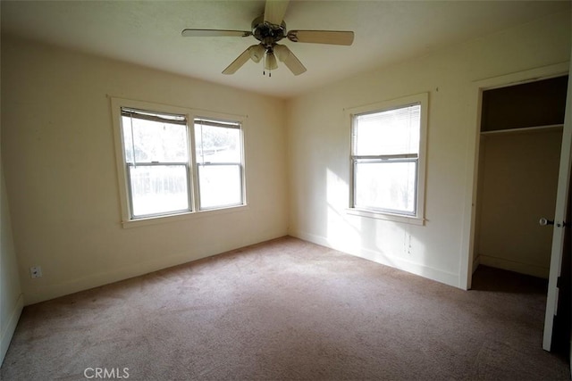 unfurnished bedroom featuring light carpet and ceiling fan