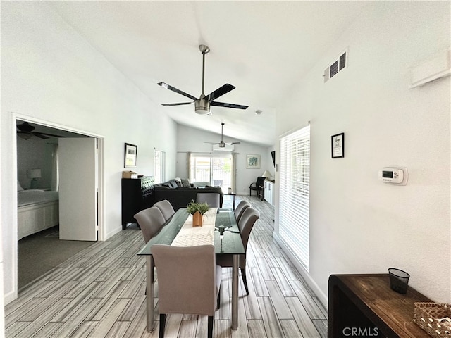 interior space with ceiling fan, high vaulted ceiling, and light wood-type flooring