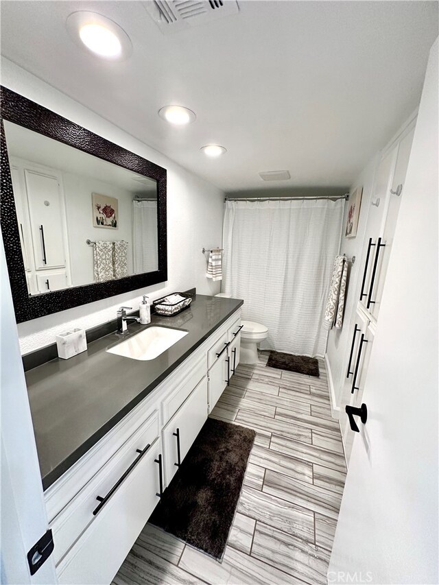 bathroom featuring toilet and vanity