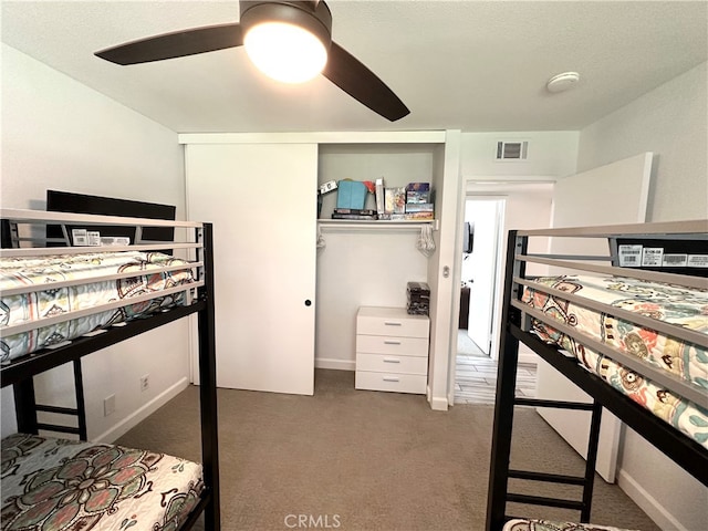 bedroom with dark carpet, a closet, and ceiling fan