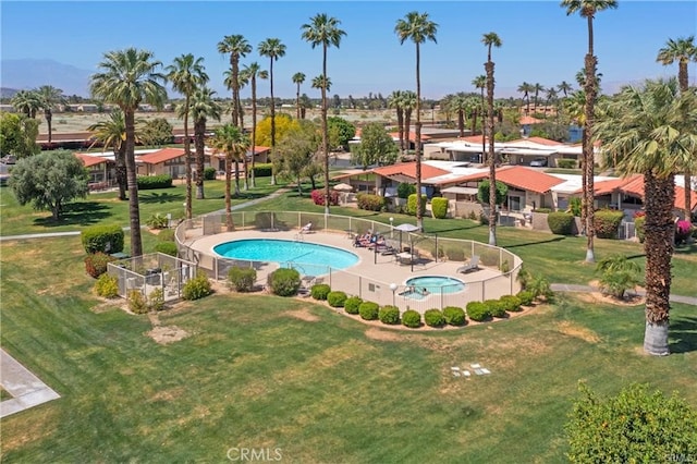 view of swimming pool featuring a patio and a lawn