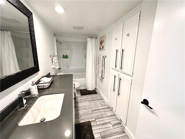 full bathroom with vanity, toilet, shower / tub combo, and hardwood / wood-style floors