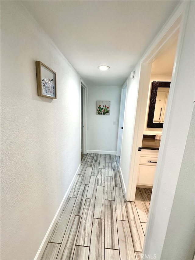 corridor with light wood-type flooring