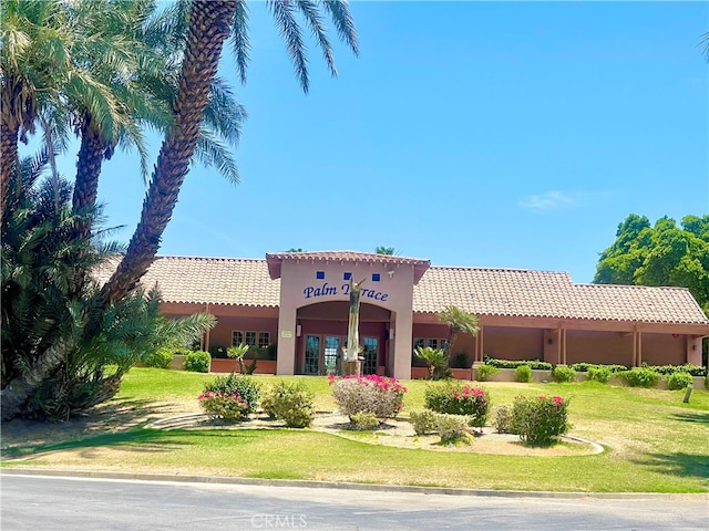 mediterranean / spanish-style home featuring a front yard