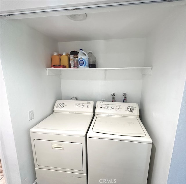 clothes washing area featuring independent washer and dryer