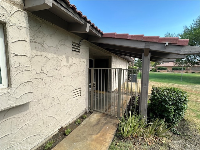 view of home's exterior featuring a lawn and central AC unit