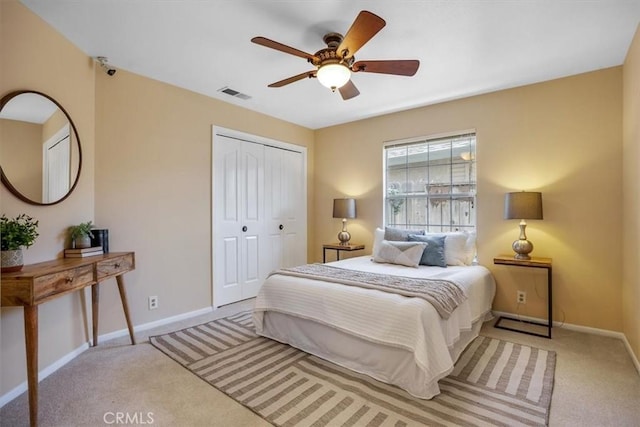 carpeted bedroom featuring ceiling fan and a closet