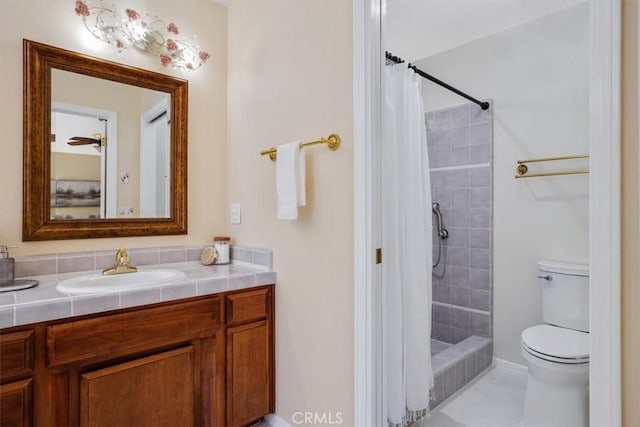 bathroom with tile patterned floors, toilet, vanity, and walk in shower