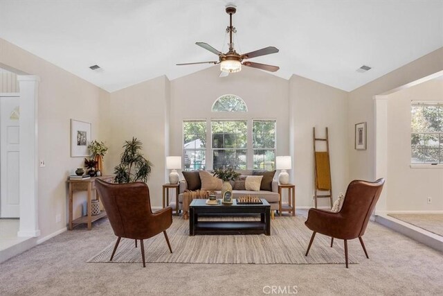 sitting room featuring light carpet, vaulted ceiling, ceiling fan, and a healthy amount of sunlight