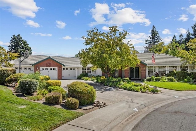 ranch-style home featuring a front yard and a garage