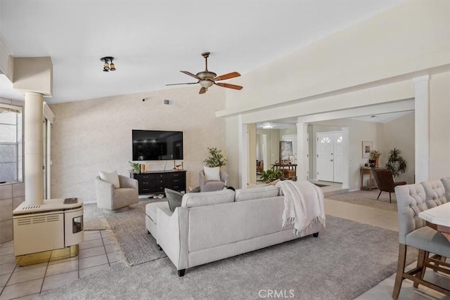 living room featuring light tile patterned floors, ceiling fan, visible vents, and decorative columns