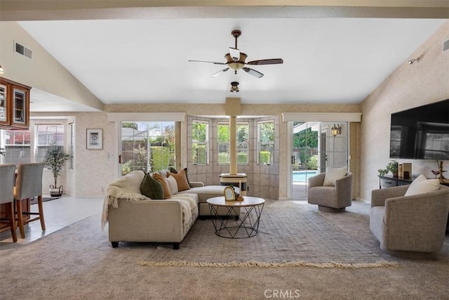 living room featuring ceiling fan, light colored carpet, and vaulted ceiling