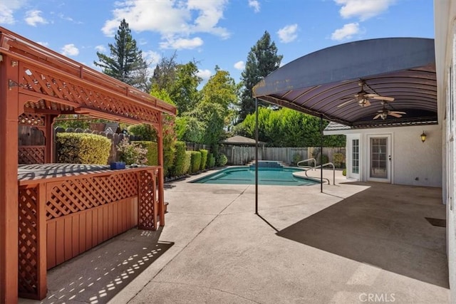 view of pool with a fenced backyard, a fenced in pool, ceiling fan, and a patio