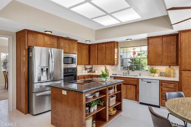 kitchen with open shelves, a center island, a sink, black appliances, and brown cabinets