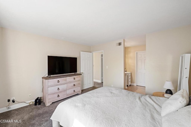 carpeted bedroom featuring connected bathroom