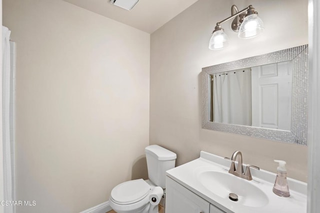 bathroom featuring vanity and toilet