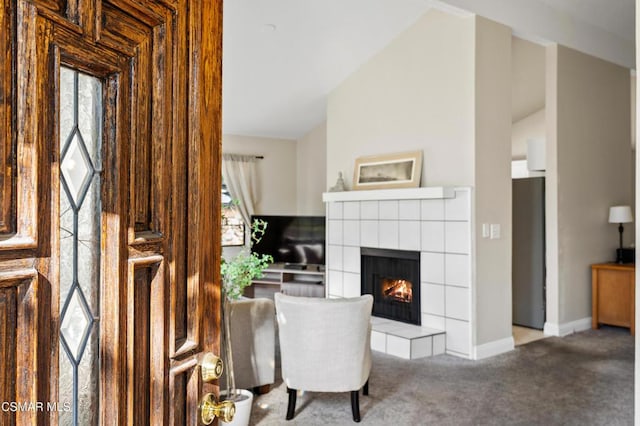 interior space with carpet flooring and a tiled fireplace