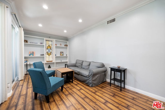 living room featuring dark hardwood / wood-style flooring and crown molding