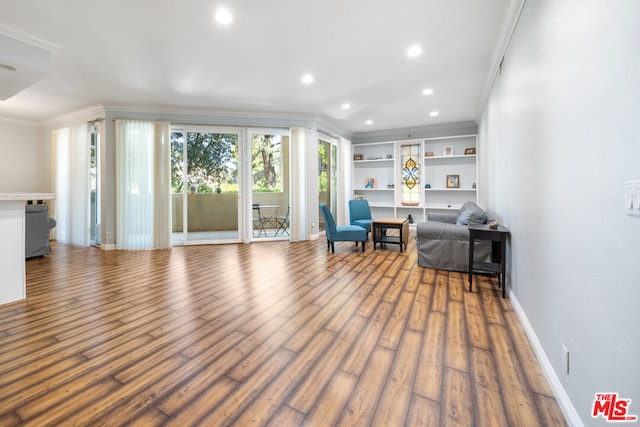 unfurnished room featuring crown molding and hardwood / wood-style flooring