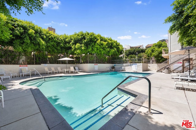 view of swimming pool with a patio area