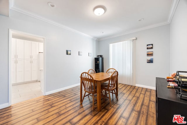 dining room featuring wood-type flooring and ornamental molding