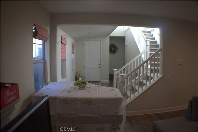 entrance foyer featuring hardwood / wood-style flooring and lofted ceiling