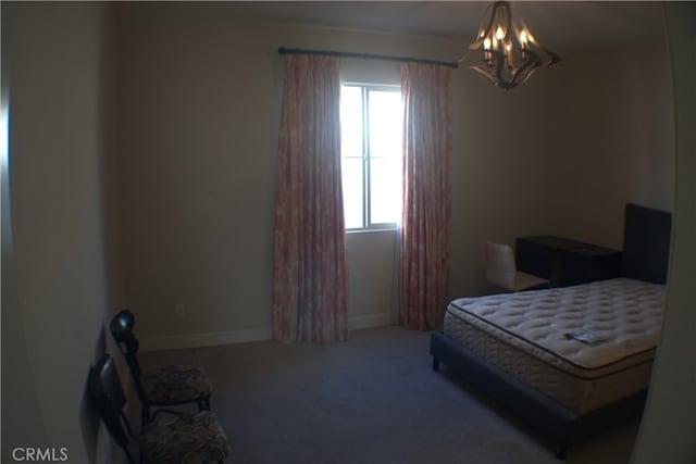 carpeted bedroom with a chandelier