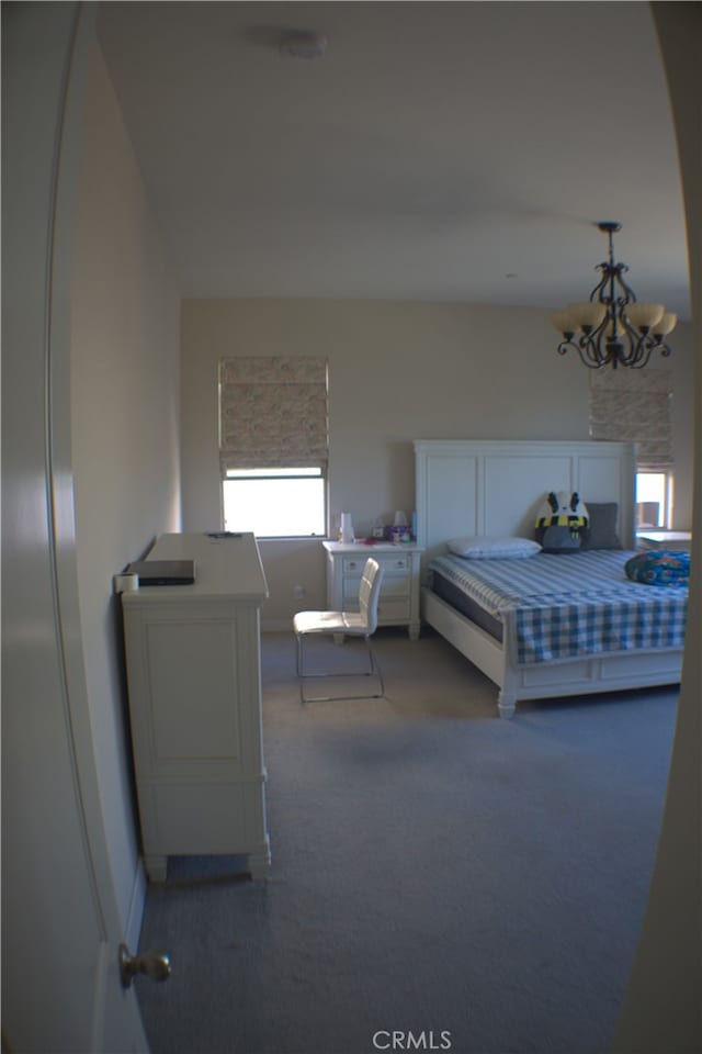 unfurnished bedroom featuring carpet flooring and a chandelier