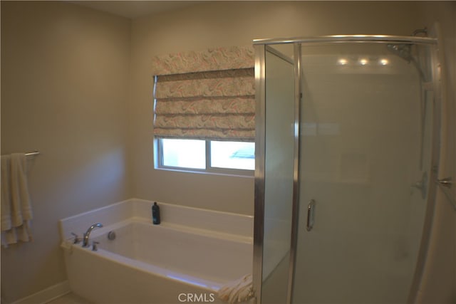 bathroom with shower with separate bathtub