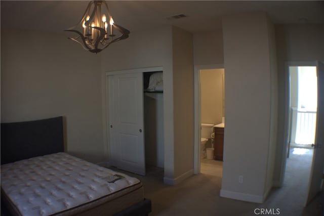 carpeted bedroom featuring a notable chandelier and a closet