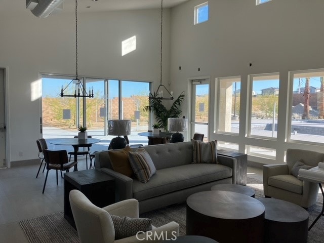 living room with high vaulted ceiling and a chandelier