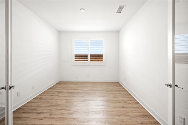 spare room with light hardwood / wood-style floors