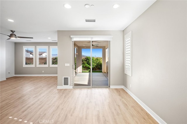 spare room featuring ceiling fan and light hardwood / wood-style flooring