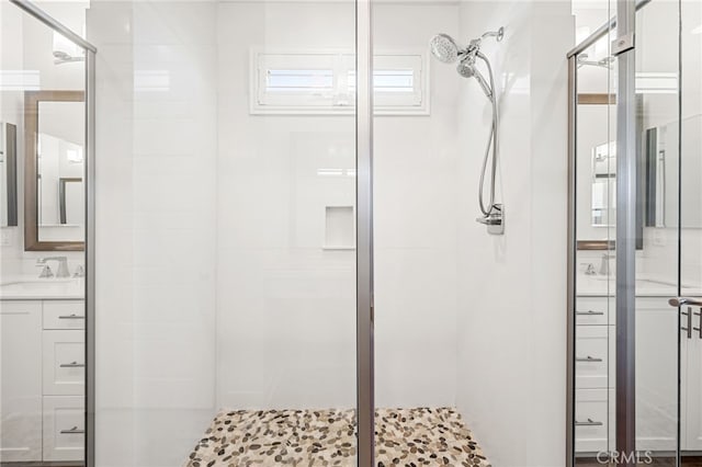 bathroom with plenty of natural light, walk in shower, and vanity