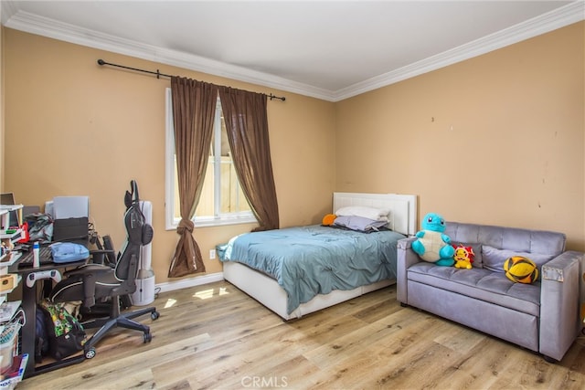 bedroom featuring light hardwood / wood-style flooring and crown molding