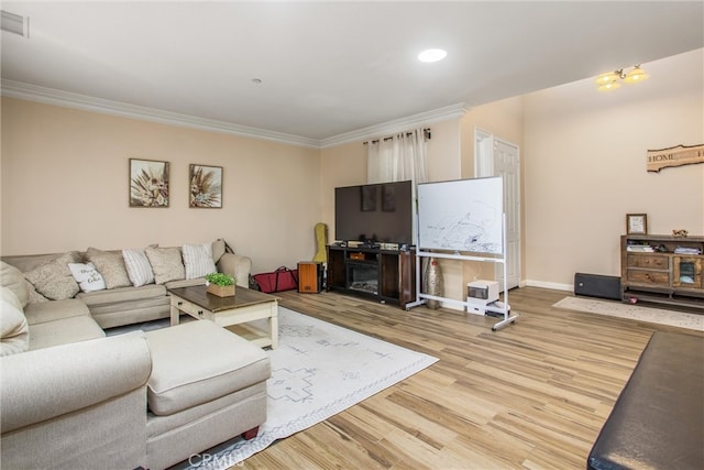 living room featuring a fireplace, ornamental molding, and hardwood / wood-style floors