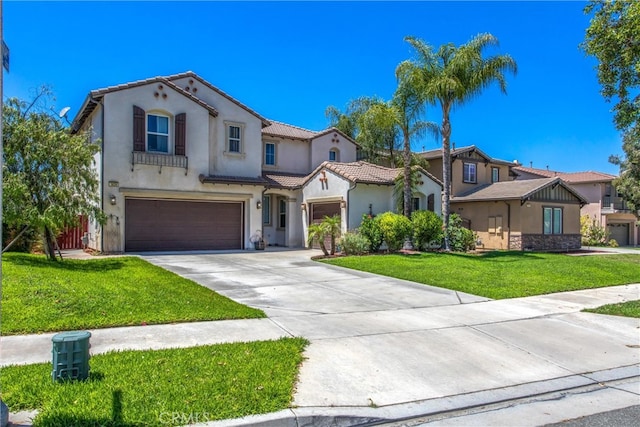 mediterranean / spanish-style house featuring a garage and a front lawn