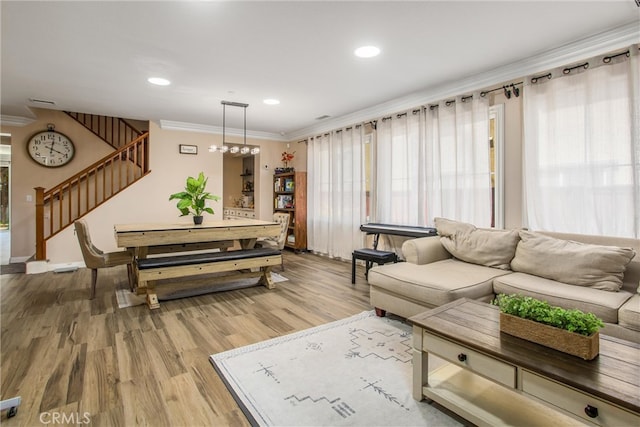 living room with crown molding and hardwood / wood-style flooring