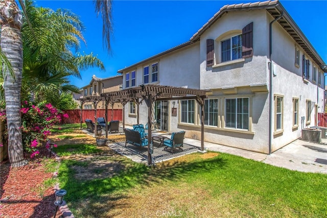 back of house featuring a yard, a pergola, and a patio area