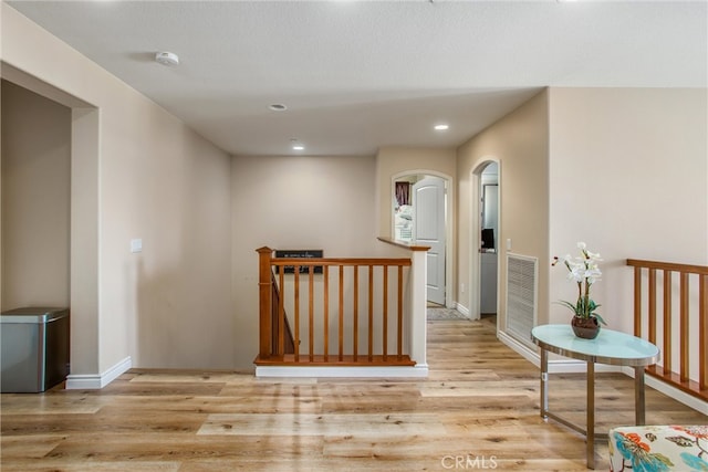 hall with light hardwood / wood-style floors