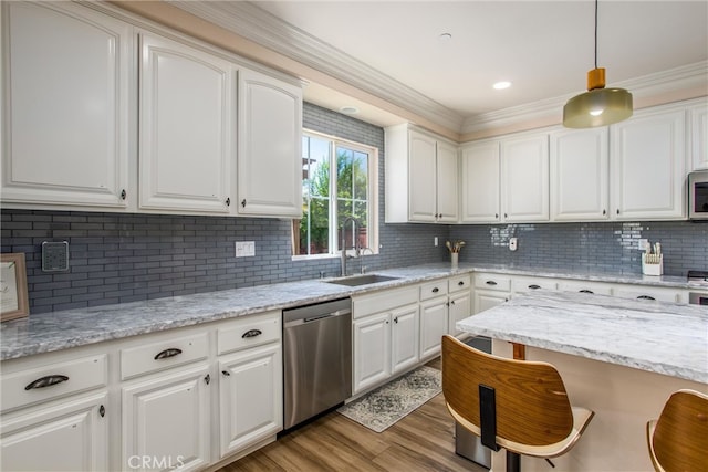 kitchen with white cabinets, stainless steel appliances, hanging light fixtures, and sink