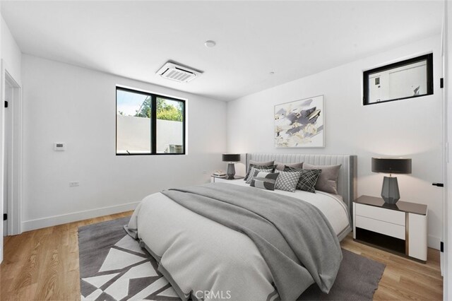 bedroom with light hardwood / wood-style floors