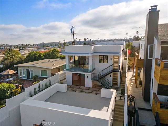 33851 Malaga Dr, Dana Point, CA 92629 - view of front of house featuring stairs, a patio, stucco siding, and a balcony